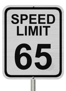 A white American road sign with words Speed Limit and 65 isolated over white Speed Limit 65 Sign